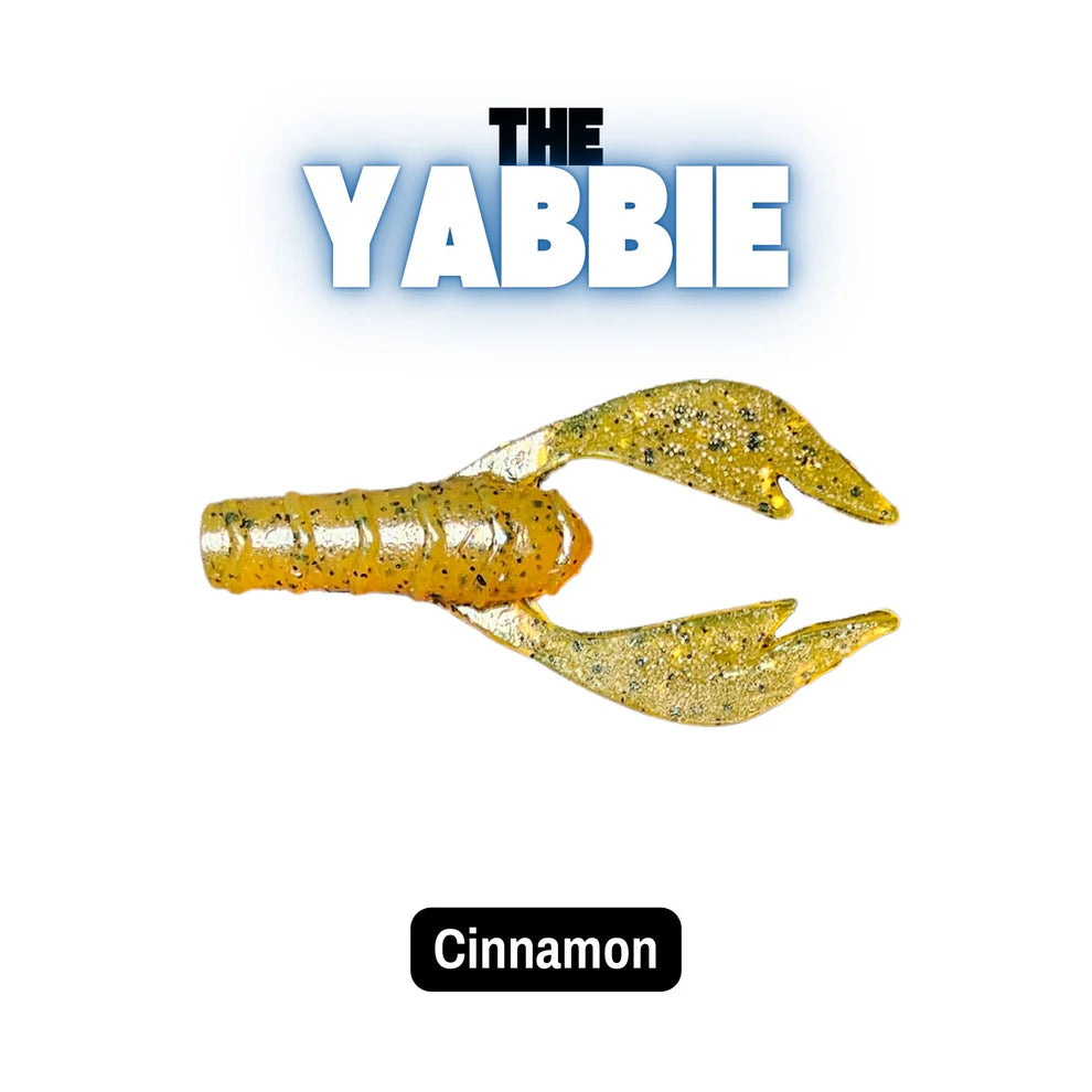 Yellow and gold crawfish trailer lure with 'The Yabbie' branding on a white background.